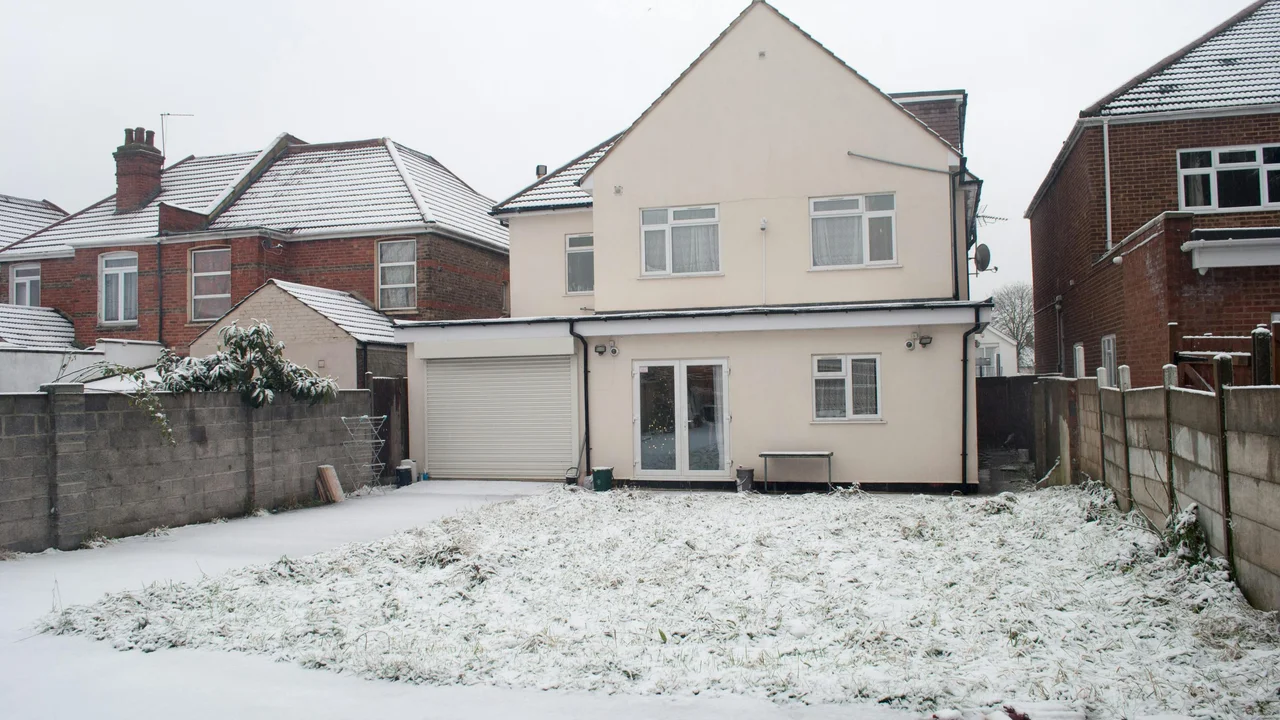 Empty UK terraced rental property with To Let sign outside