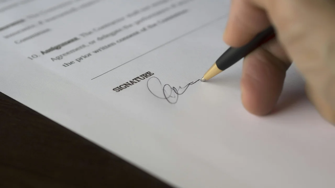 Formal UK official document being signed, enforcement notice paperwork