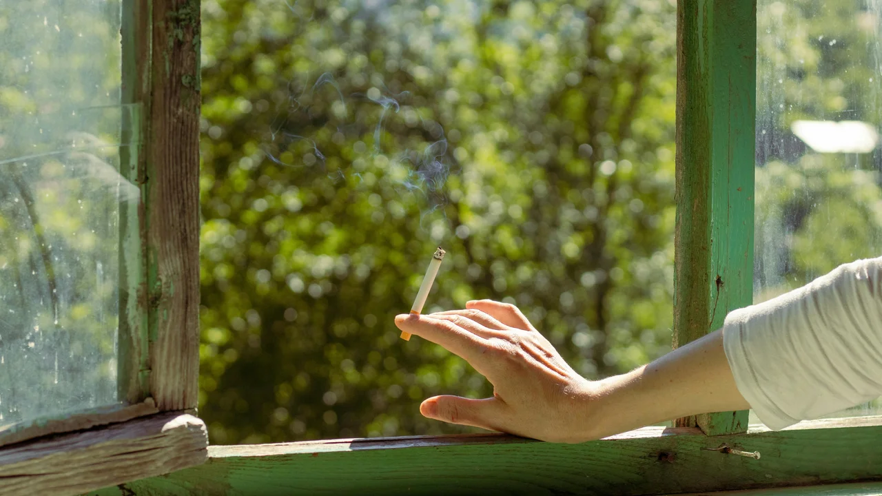 Hands opening UK window in morning light, daily ventilation routine