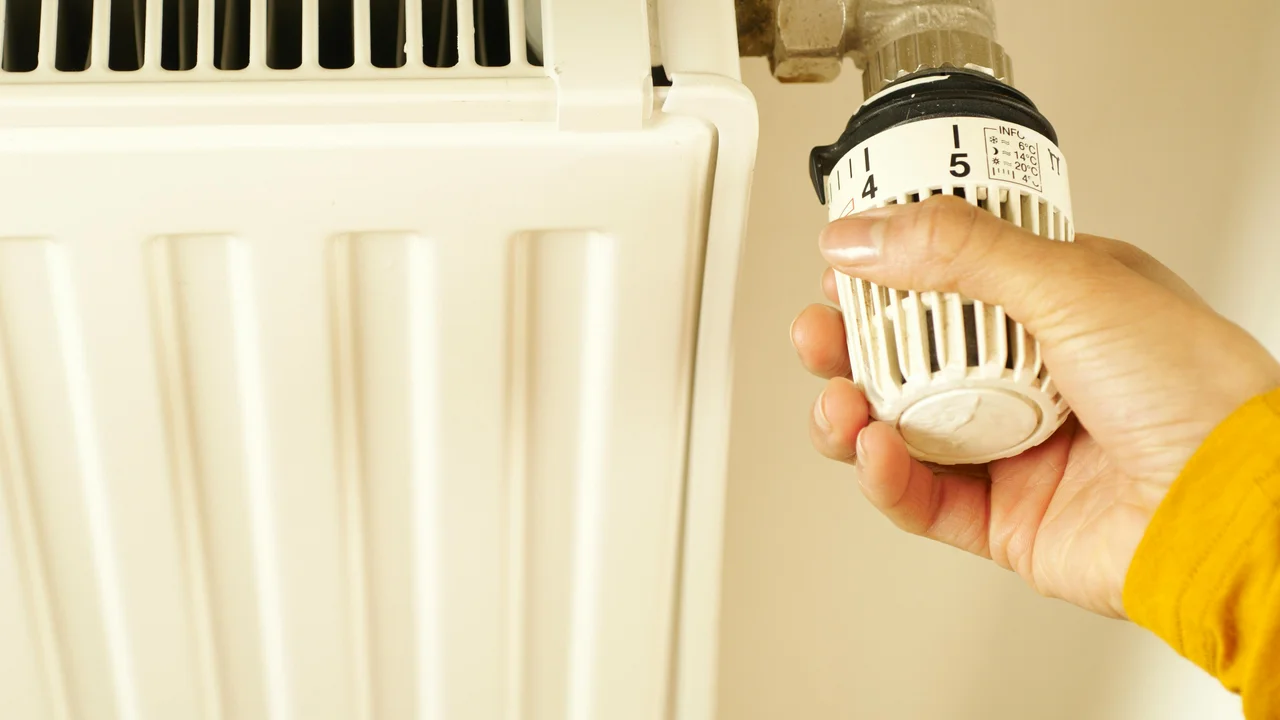 Radiator thermostat in UK home interior, winter heating control